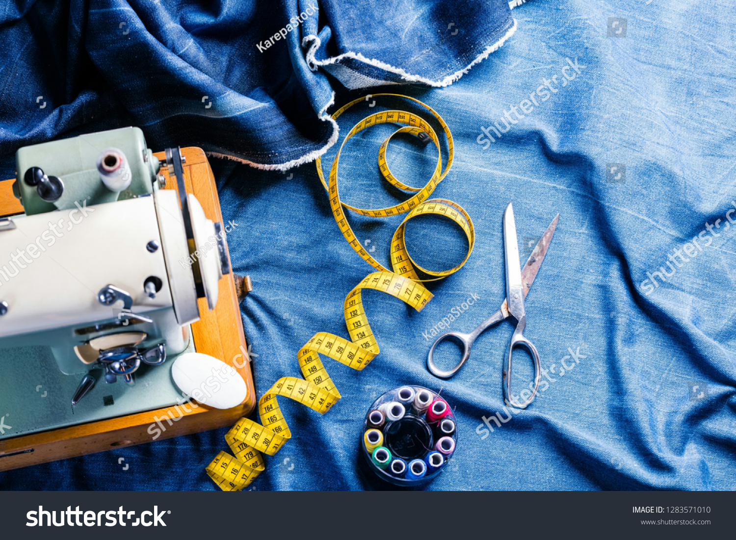 sewing indigo denim jeans with sewing machine, garment industrial concept #1283571010