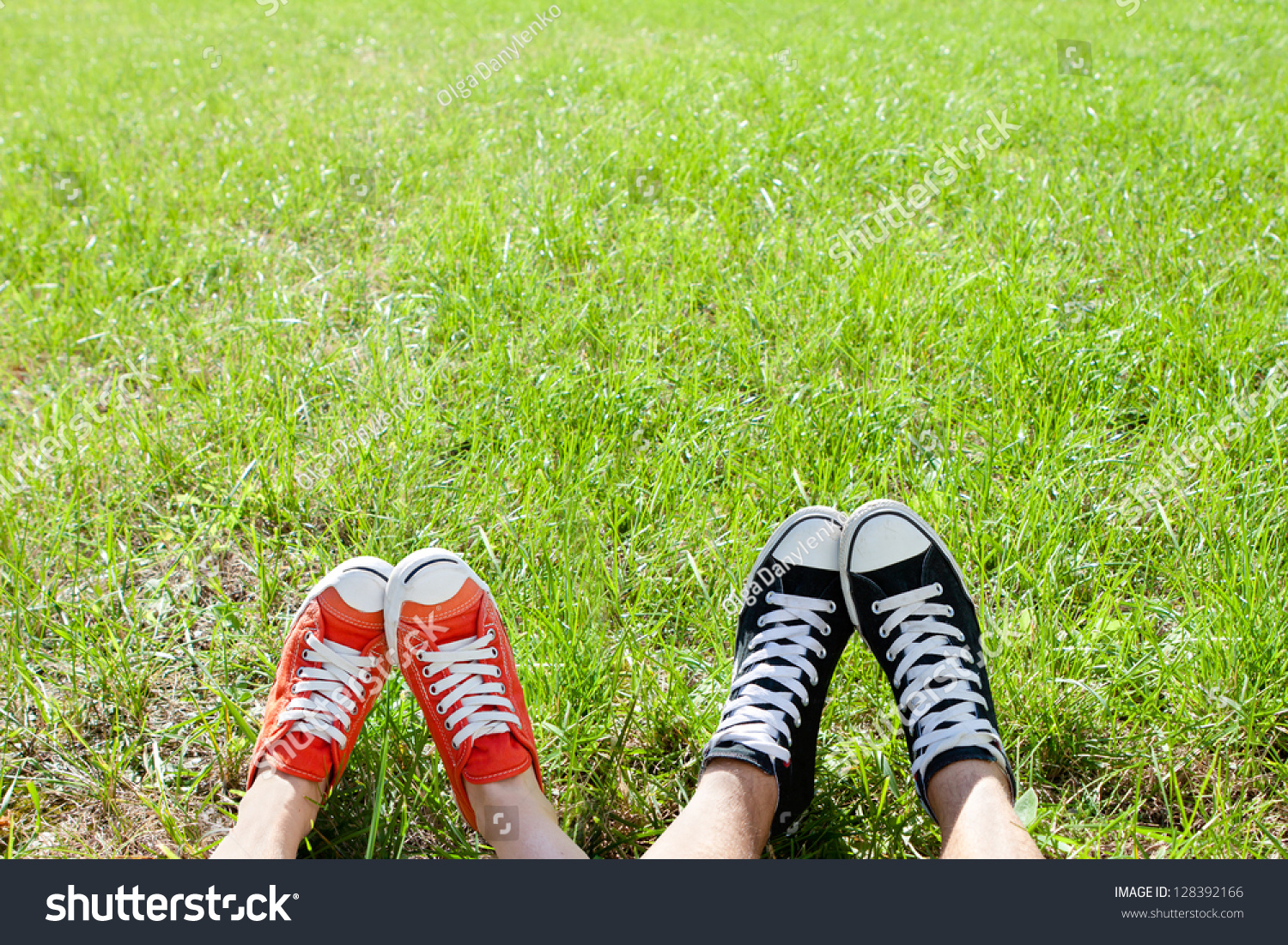 Friendly couple in sneackers in green grass #128392166