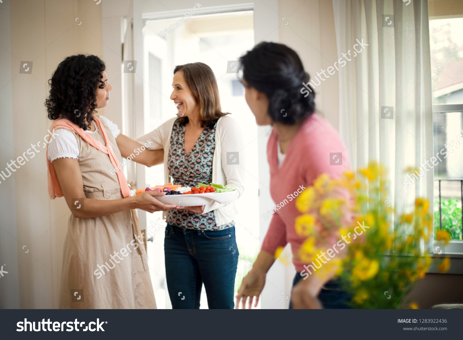 Happy mature woman greeting her neighbors. #1283922436