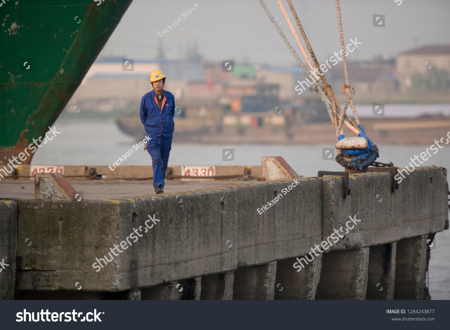 Portrait of a mid-adult man walking on a wharf. #1284243877