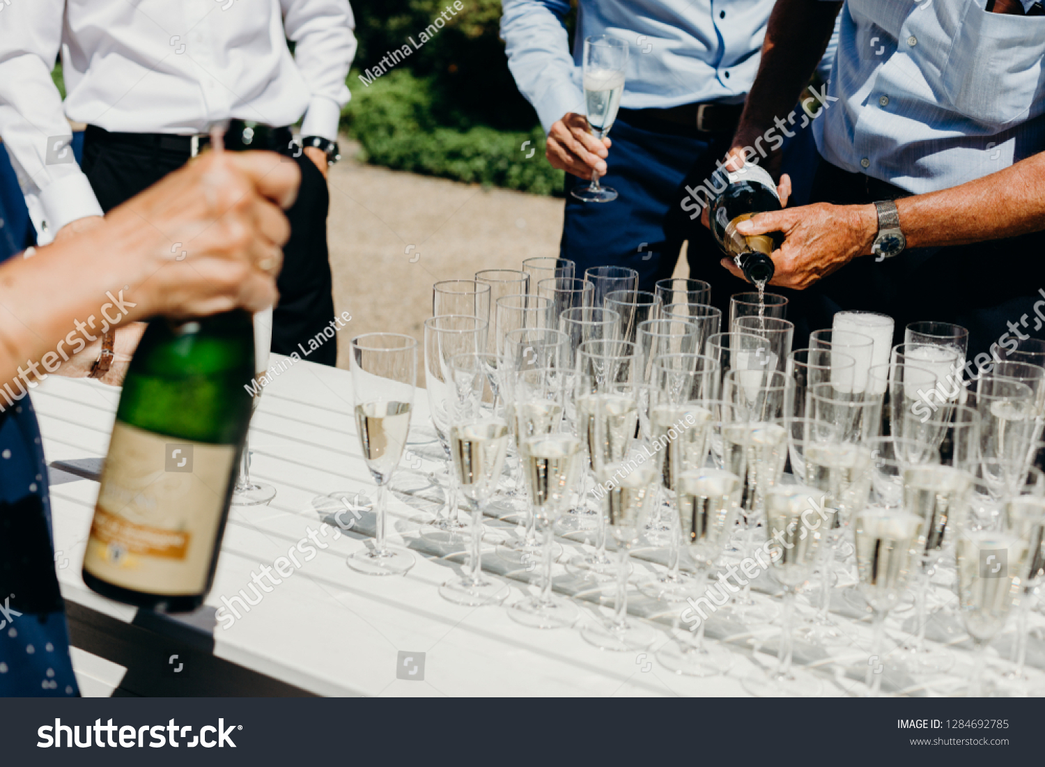 Popping bottles to celebrate bride and groom, wedding toast, hands #1284692785