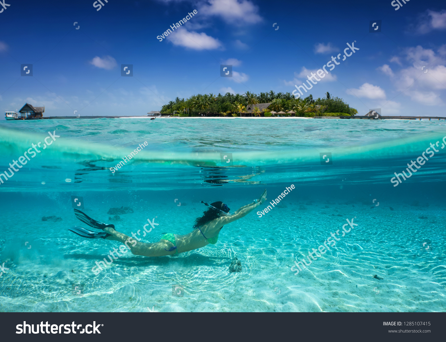Woman in bikini snorkeling under turquoise, tropical water in the Maldives; split picture under and over water #1285107415
