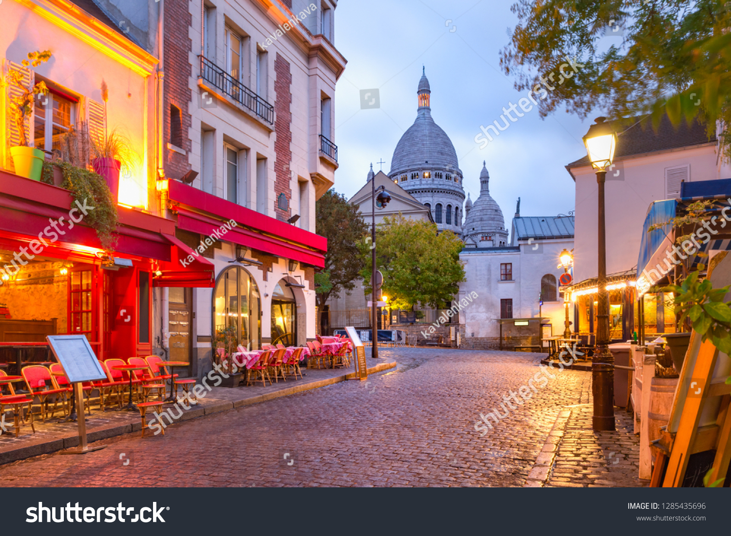 The Place du Tertre with tables of cafe and the Sacre-Coeur in the morning, quarter Montmartre in Paris, France #1285435696