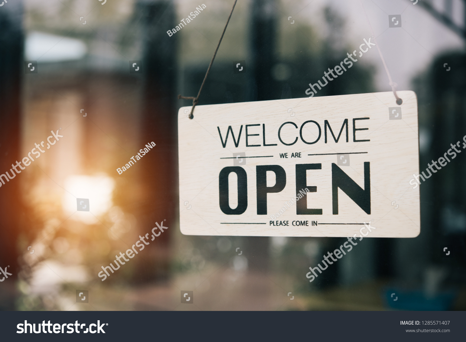 "Open" on cafe or restaurant hang on door at entrance. #1285571407