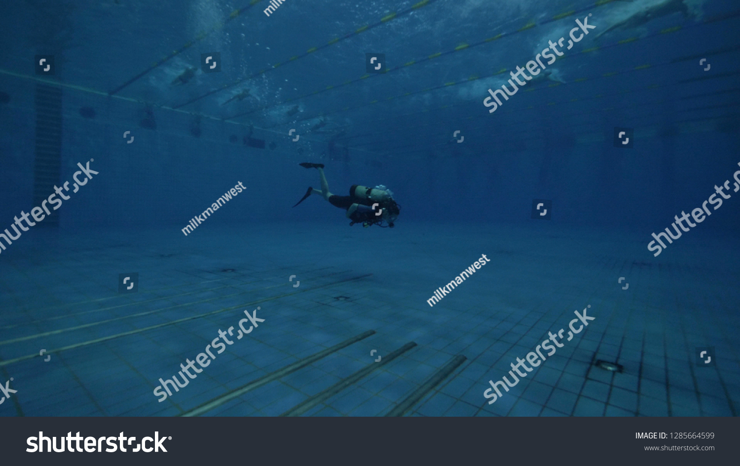 Diver student with scuba tank and scuba mask learning to deep diving in pool #1285664599