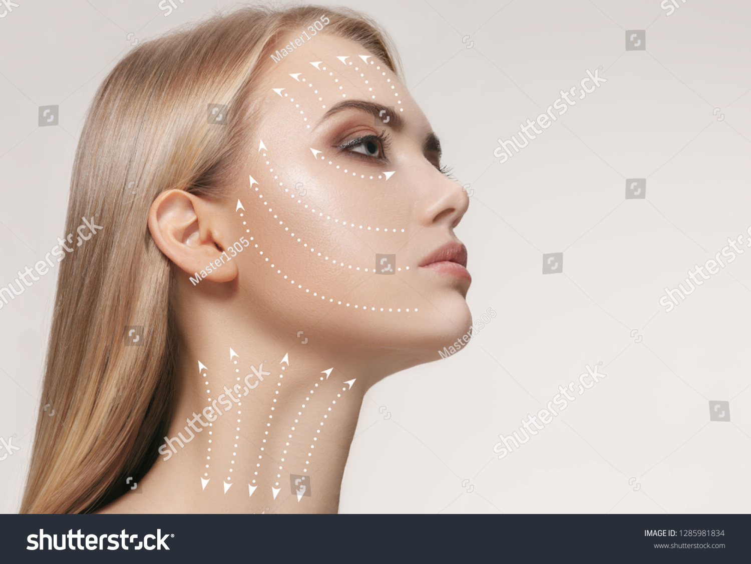 Close-up portrait of young, beautiful and healthy woman with arrows on her face. The spa, surgery, face lifting and skin care concept #1285981834