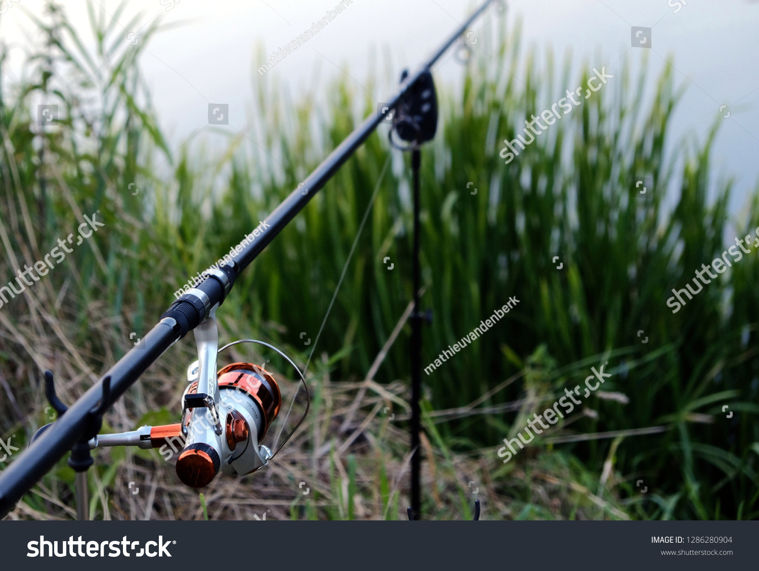 Fishing rod by a river in the summer #1286280904