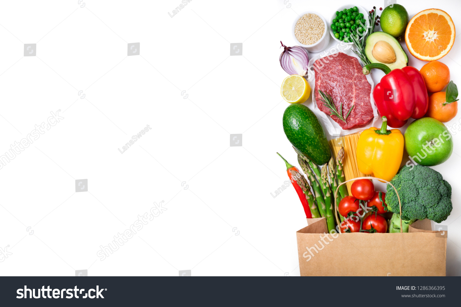 Healthy food background. Healthy food in paper bag meat beef, fruits, vegetables and pasta on white background. Shopping food supermarket concept. Long format with copy space #1286366395