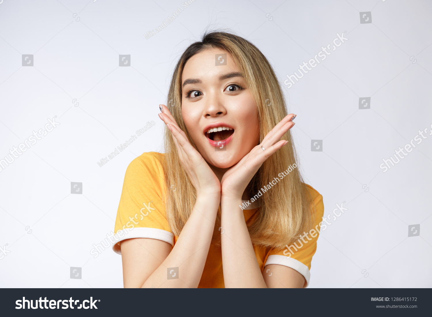 Young Asian woman with surprised excited happy screaming. Cheerful girl with funny joyful face expression #1286415172