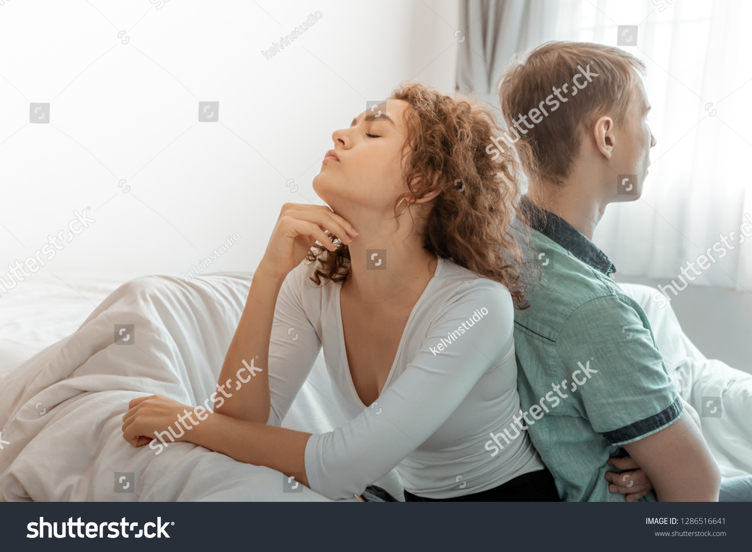 Unhappy young man and woman sitting separately on couch, bad relationships #1286516641