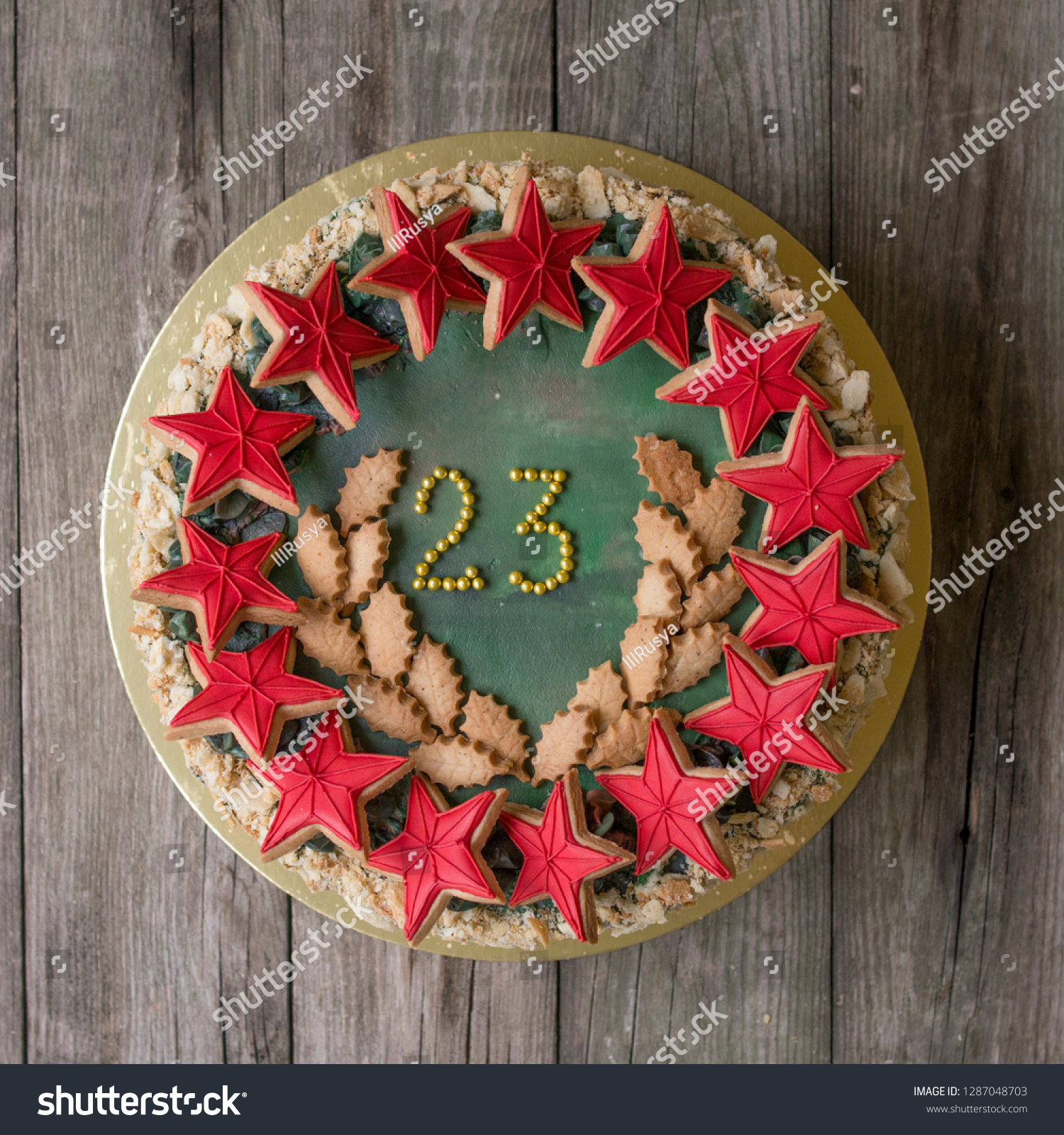Sweet Napoleon cake with decor on 23 february holiday - Red stars cookies and number 23 - on wooden background. Close up, Selective focus #1287048703