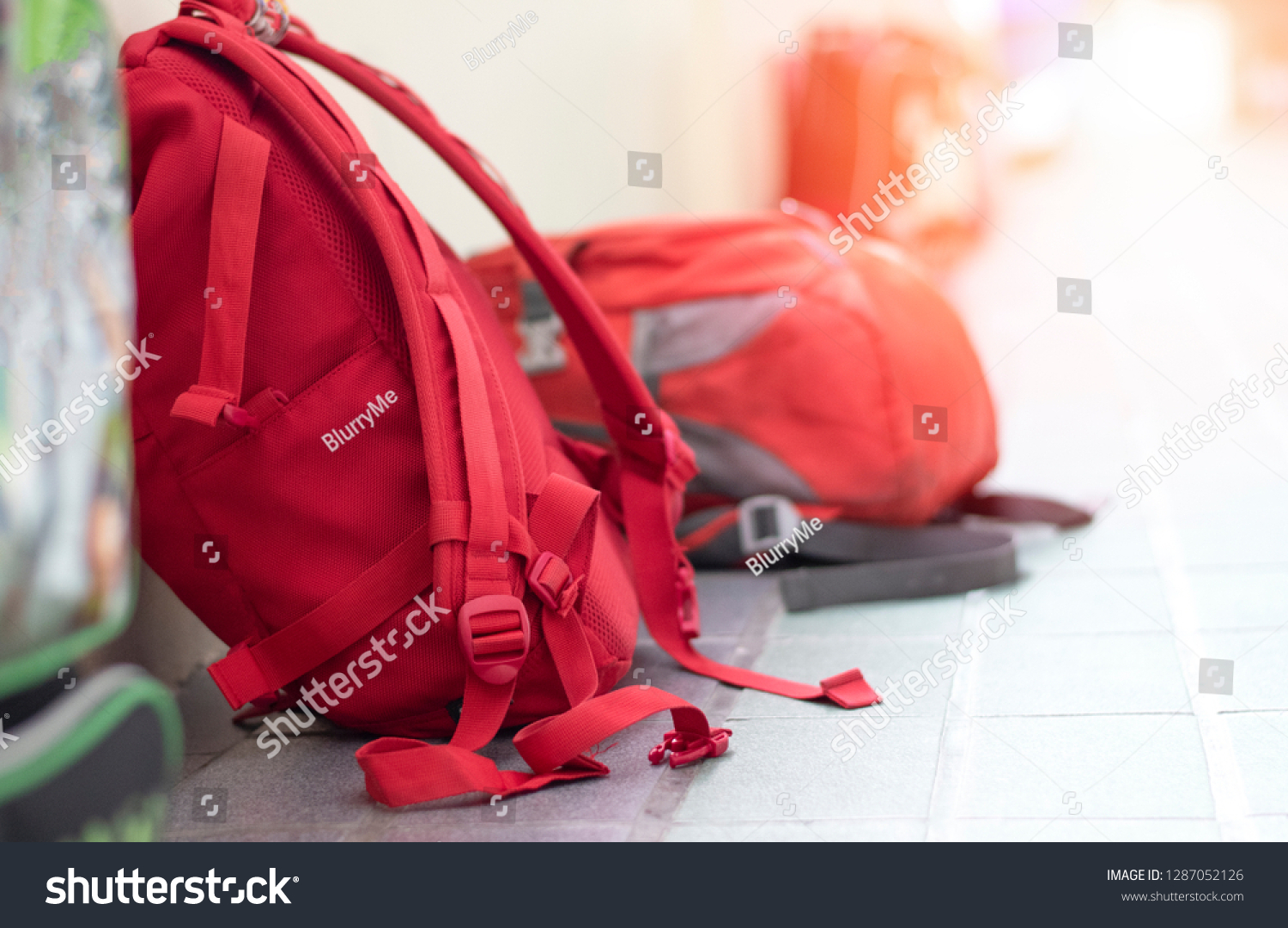 Back to school background concept. Student backpacks of children lay down on the floor at hallway corridor in front of classroom on start of semester day. #1287052126