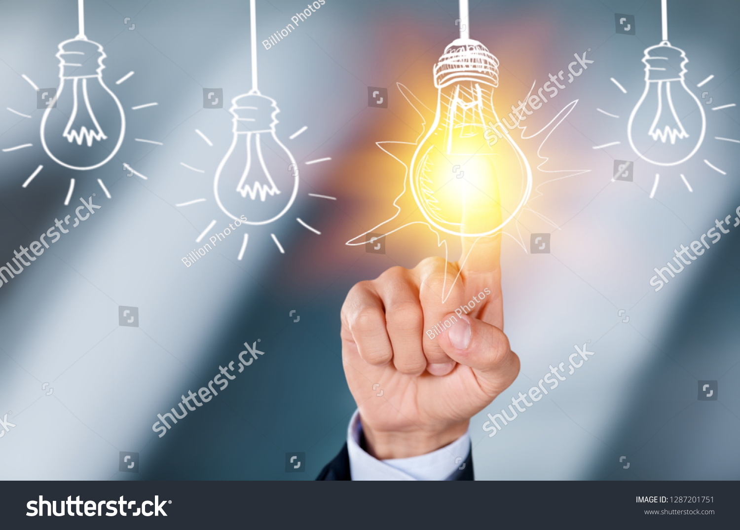 Businessman touching light bulbs #1287201751