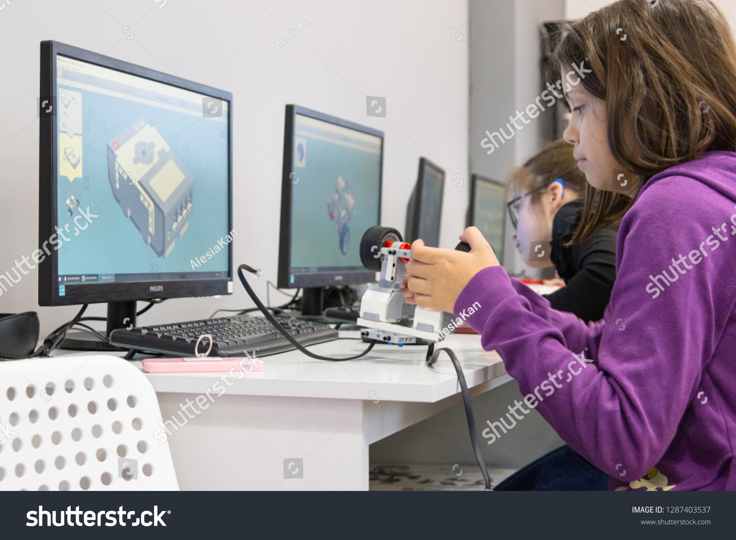 Minsk, Belarus. January, 2019. Boys and girls construct and code robots. Lego Mindstorms EV 3 robot. STEM education.   Robotics class for child and teen. STEAM. Mathematics. Science. Technology. Art. #1287403537