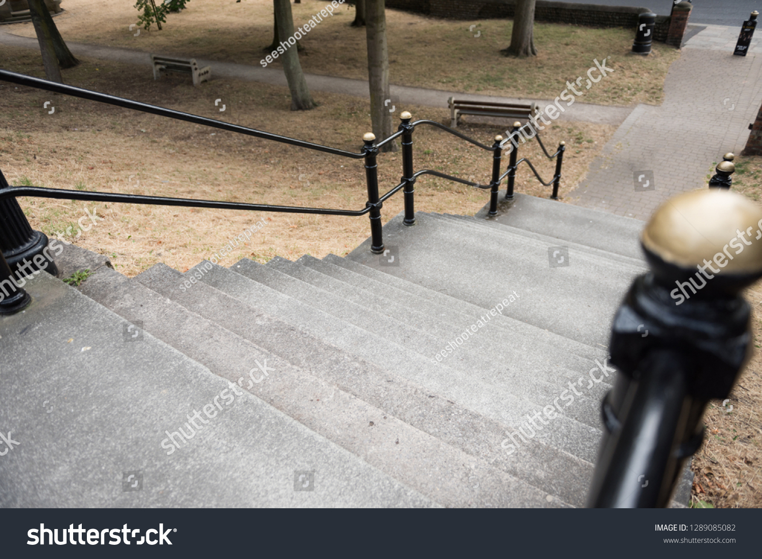An empty French style paris style flight of stairs, with a steel metal handrail. beautiful victorian architecture, perfect for composites. compositing.  #1289085082