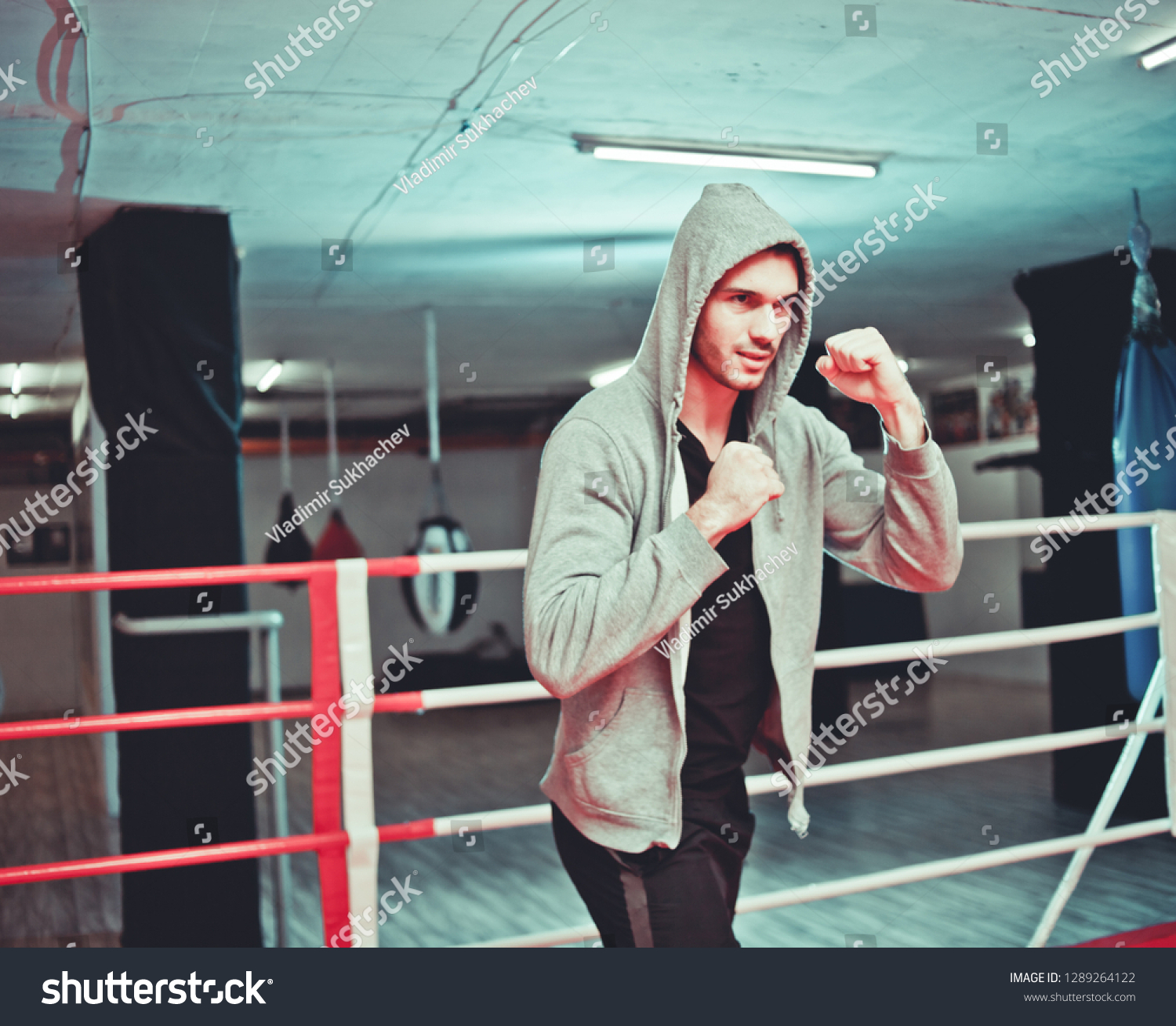 The guy in the hoodie boxing without gloves in the ring
 #1289264122