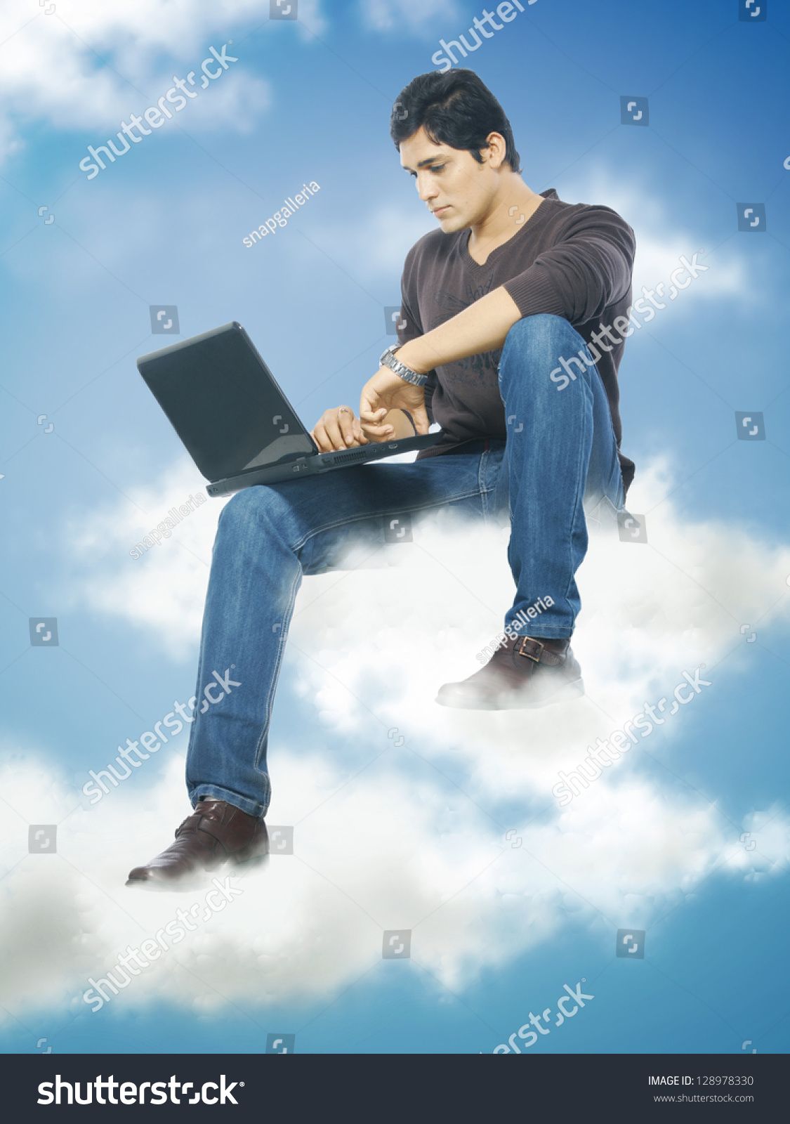 young man working on laptop in cloud in sky #128978330
