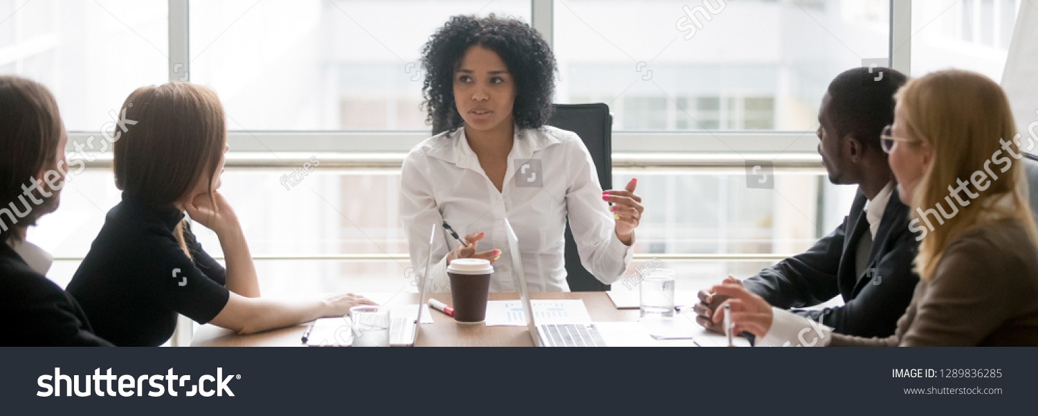 Horizontal photo people sitting at boardroom african business woman talking with staff at formal meeting briefing, diverse client partners listens boss ceo team leader banner for website header design #1289836285