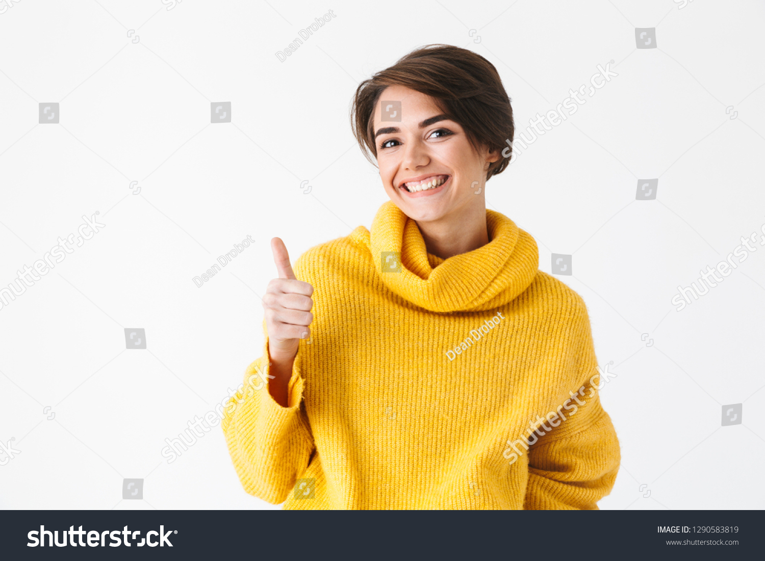 Happy cheerful girl wearing hoodie standing isolated over white background, thumbs up #1290583819
