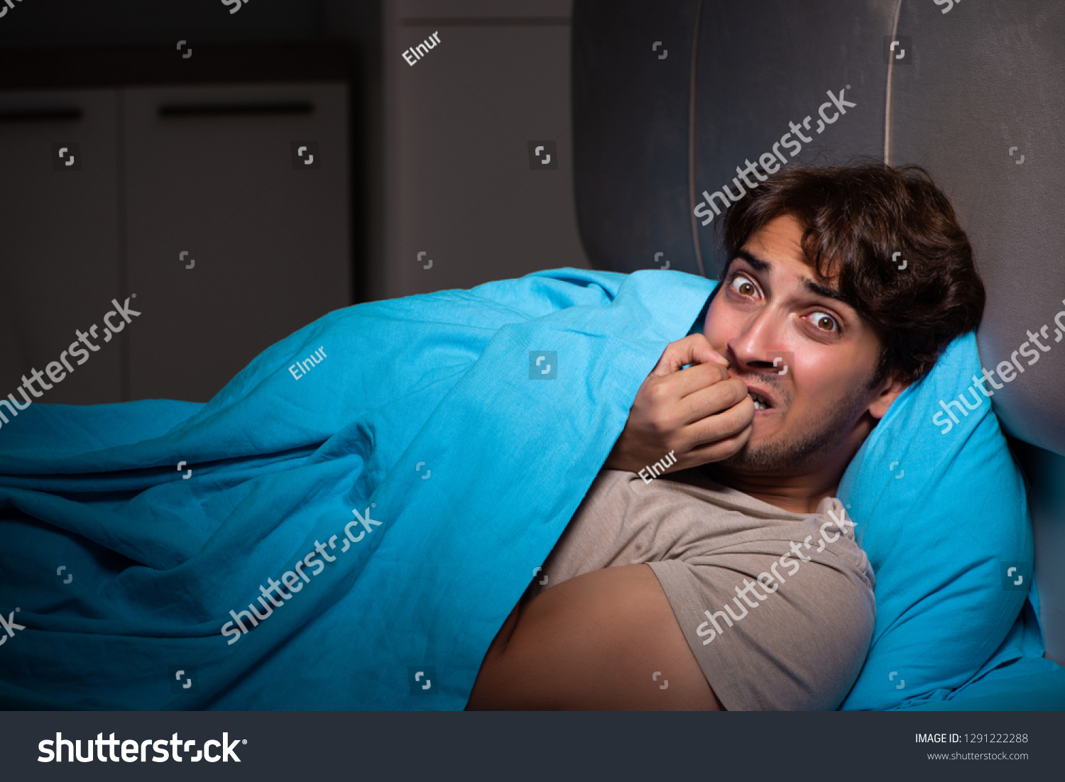 Young man scared in his bed having nightmares #1291222288