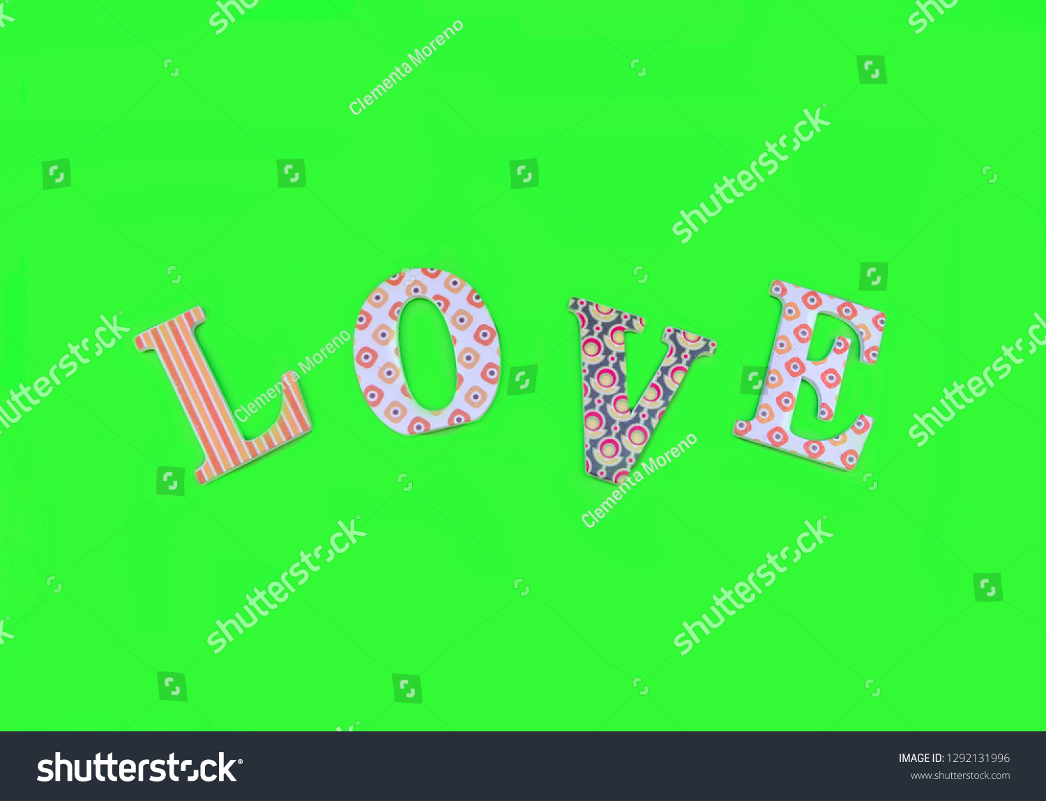 Vintage wooden love letters on green background with copy space. Romanticism concept. #1292131996