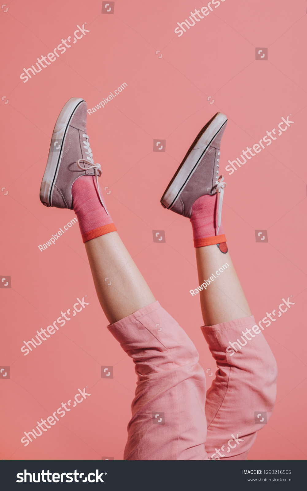 Woman legs in pink pants up in the air #1293216505