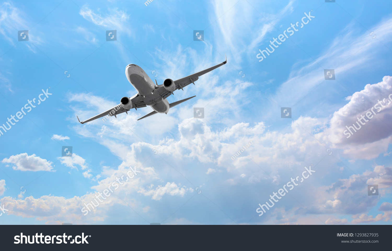 White passenger airplane flying in the sky amazing clouds in the background - Travel by air transport #1293827935