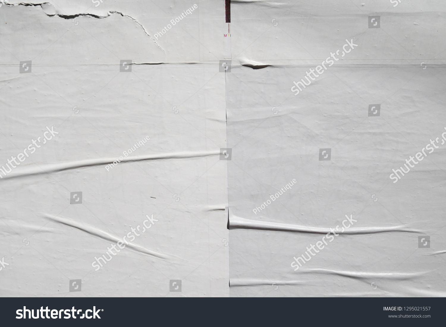 creased crinkled lined overlaying layers of white posters #1295021557