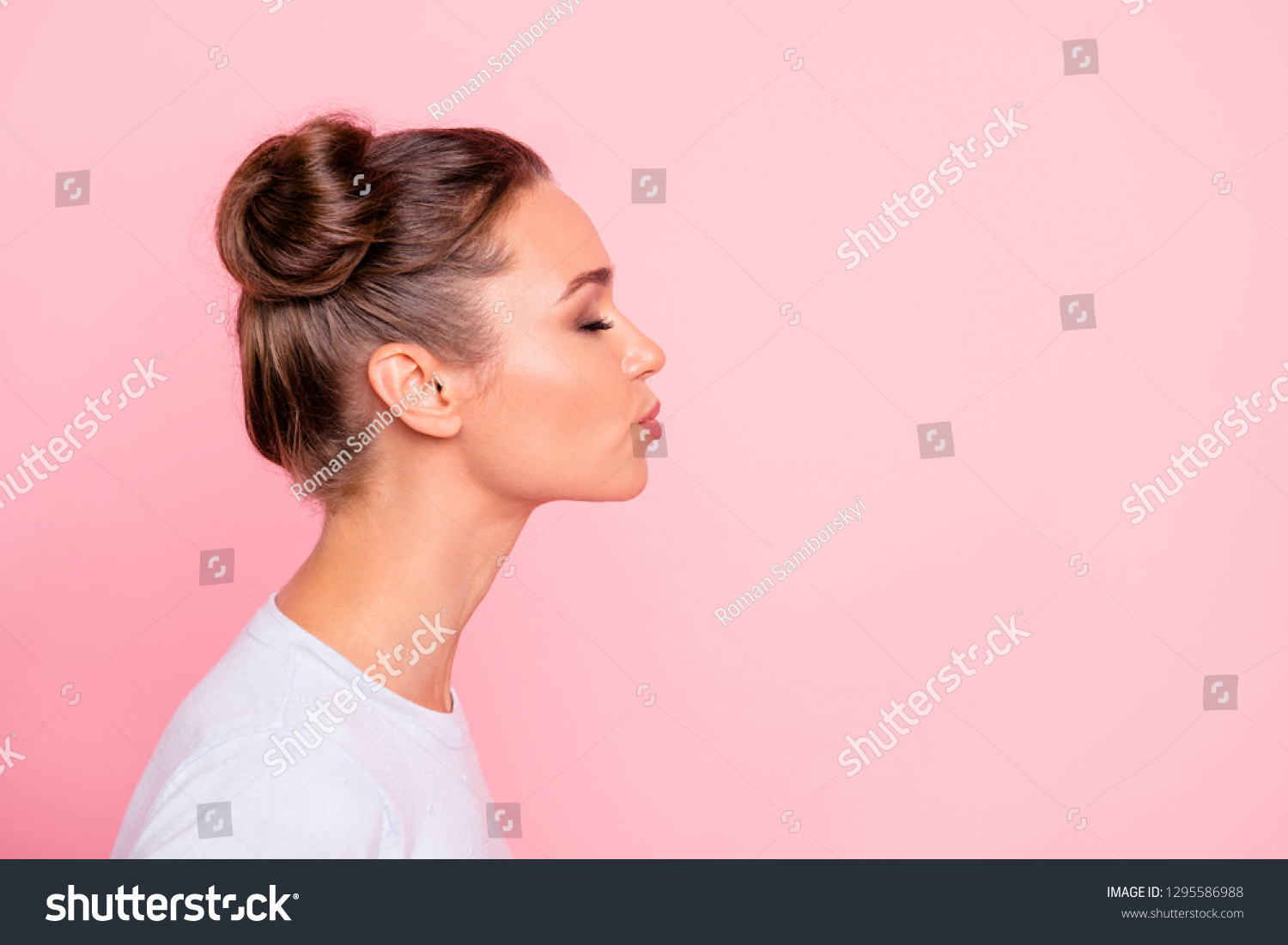 Profile side view portrait of her she nice cute attractive lovely sweet cheerful girl lady kissing you isolated over pastel pink background #1295586988