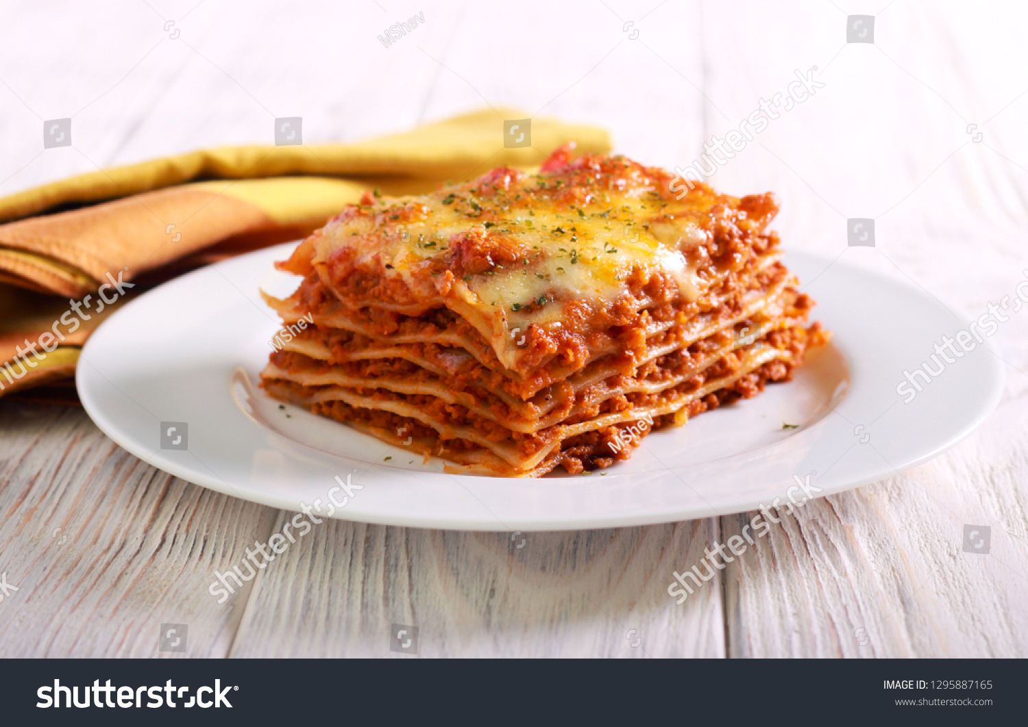 Slice of lasagna  on plate selective focus #1295887165