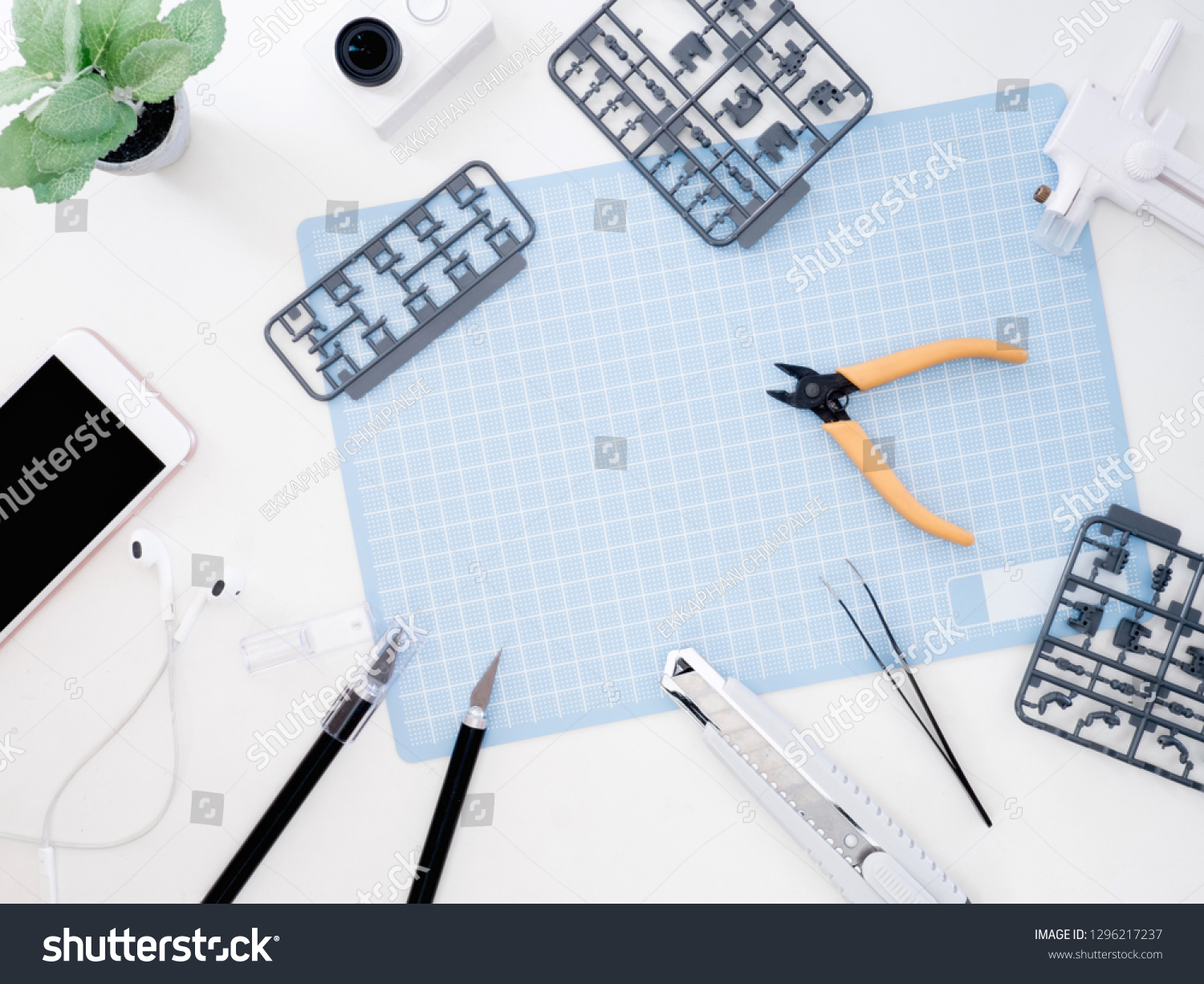 top view of hobbies concept with cutting mat, Plastic model part kits and tool kits on white background with copy space. #1296217237