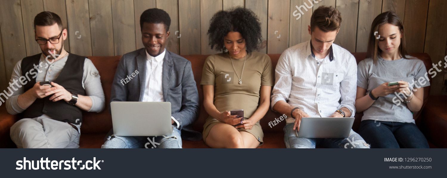 Multi-ethnic businesspeople sitting in row on couch absorbed in mobile phones computers girls guys addicted in gadgets devices. Overuse dependence on internet concept, banner for website header design #1296270250