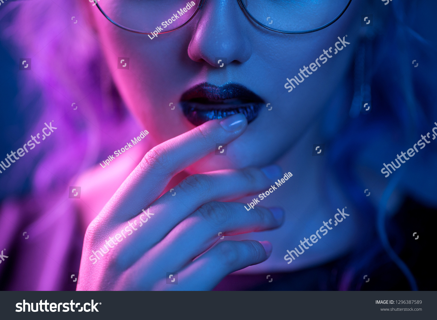 Sensitive Girl Touching Bright Lips. Wearing Glasses. Posing In Blue Light. Creative Make Up Concept. #1296387589