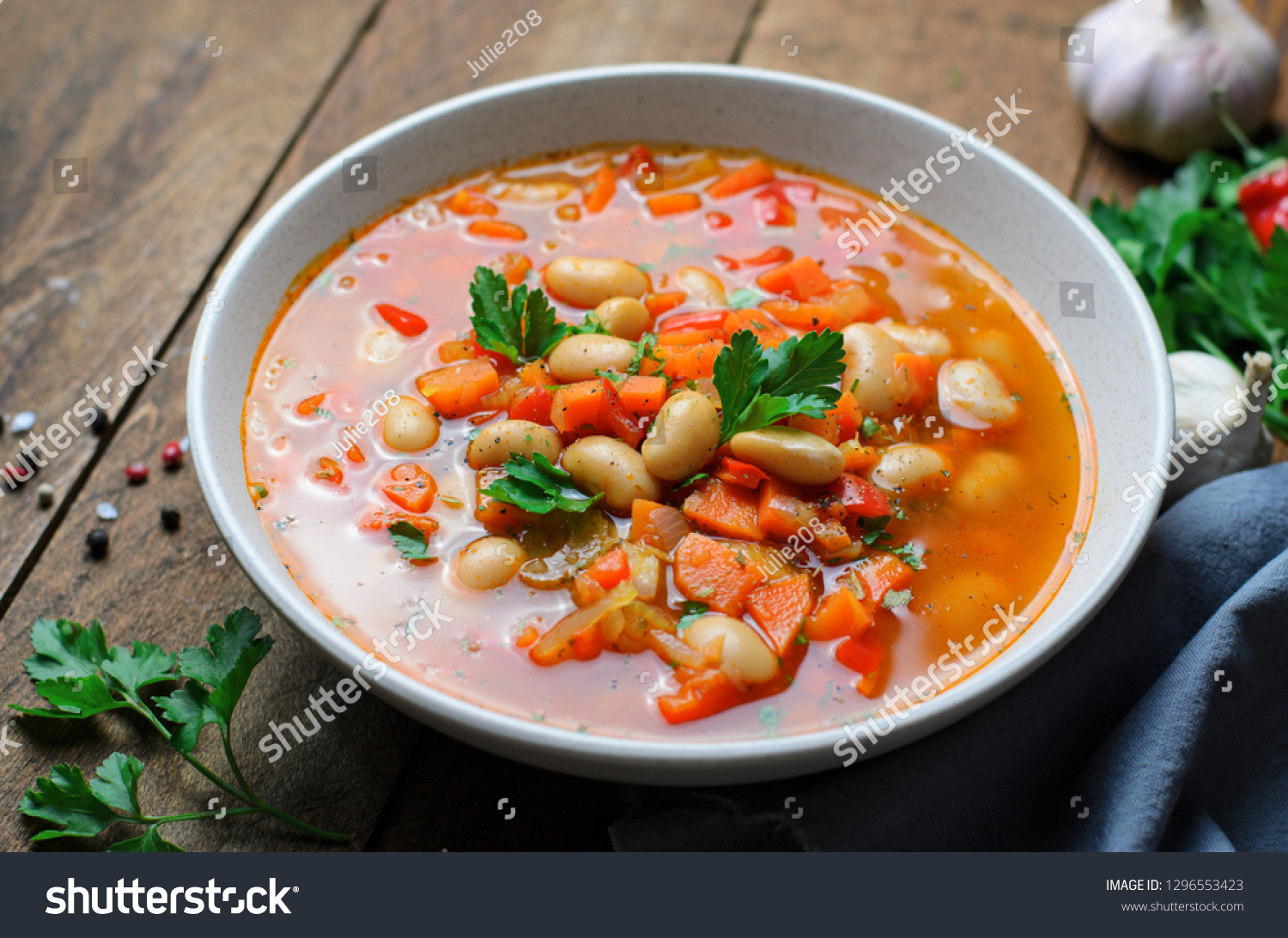 Vegetable Soup with White Beans, Homemade Soup on Dark Wooden Background, Vegetarian Food, Top View #1296553423