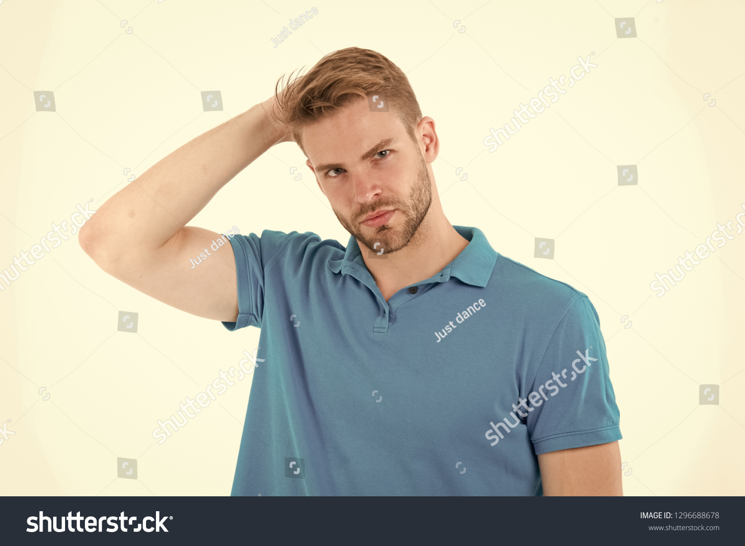 Fashion model touch stylish hair isolated on white background. Man with beard on unshaven face skin. Bearded man in blue tshirt. Skincare and barber salon. Style or trend and hairstyle concept. #1296688678