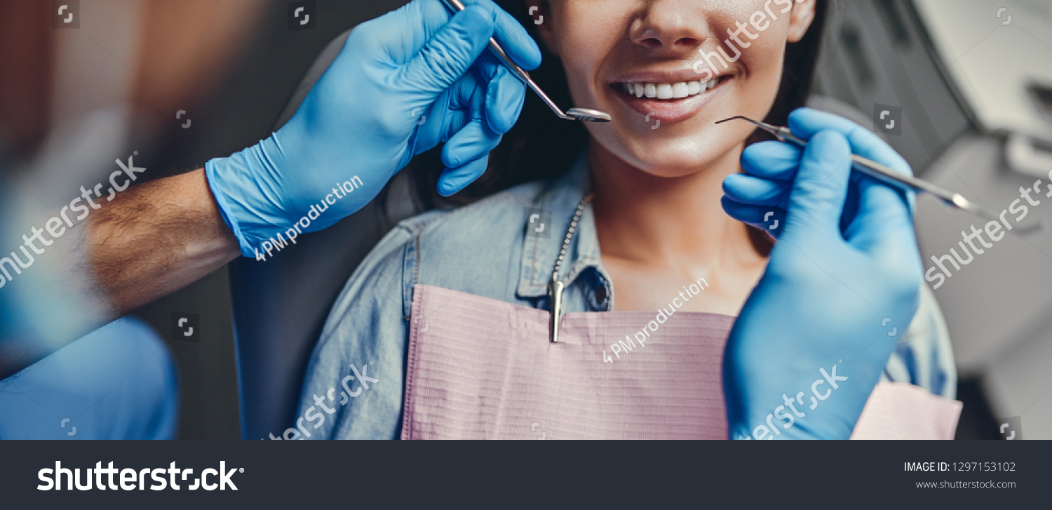 Attractive young woman in stomatology clinic with male dentist. Healthy teeth concept. #1297153102