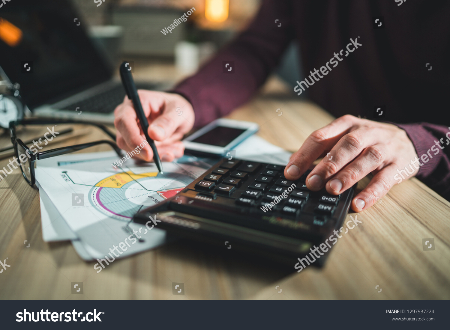 Male accountant working home making calculations. Savings, finance, economy concept.  #1297937224