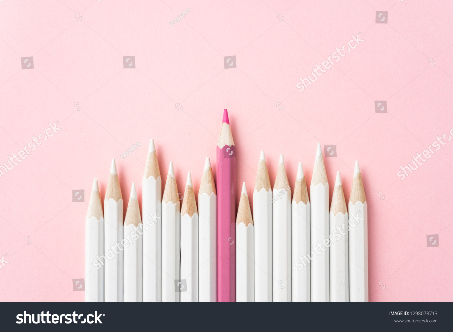 Business and design concept - lot of white pencils and one color pencil on pink paper background. It's symbol of leadership, teamwork, success and unique. #1298078713