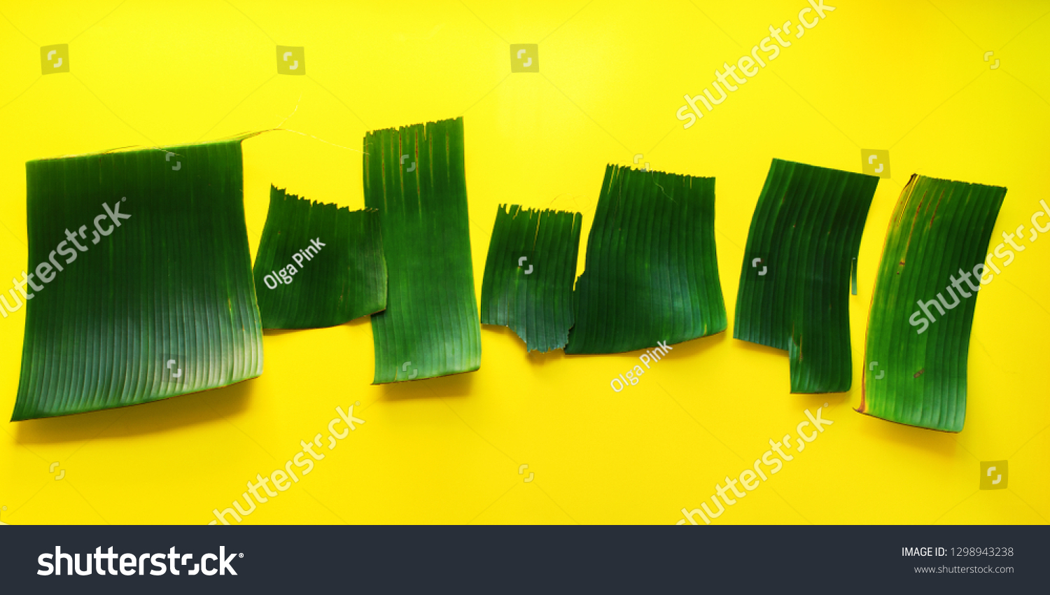Empty templates for letters from green tropical palm leaves on yellow textured background. Original handmade idea from natural material for summer design #1298943238