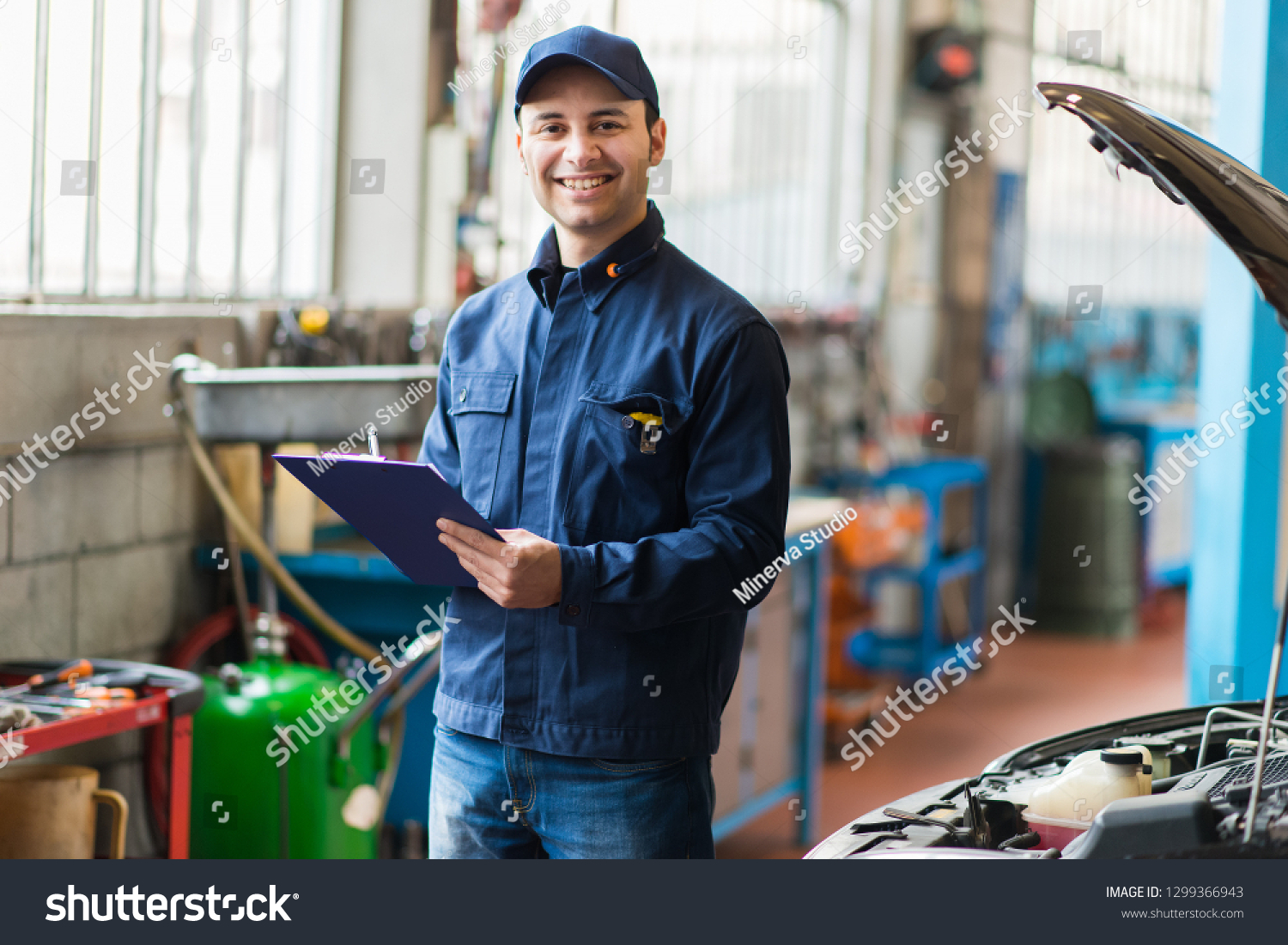 Portrait of a mechanic at work in his garage #1299366943