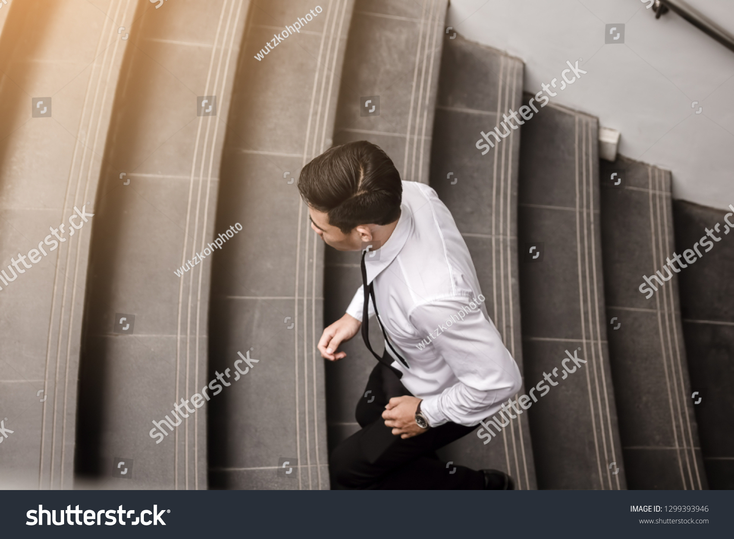 Businessman running up stairway going to work. #1299393946