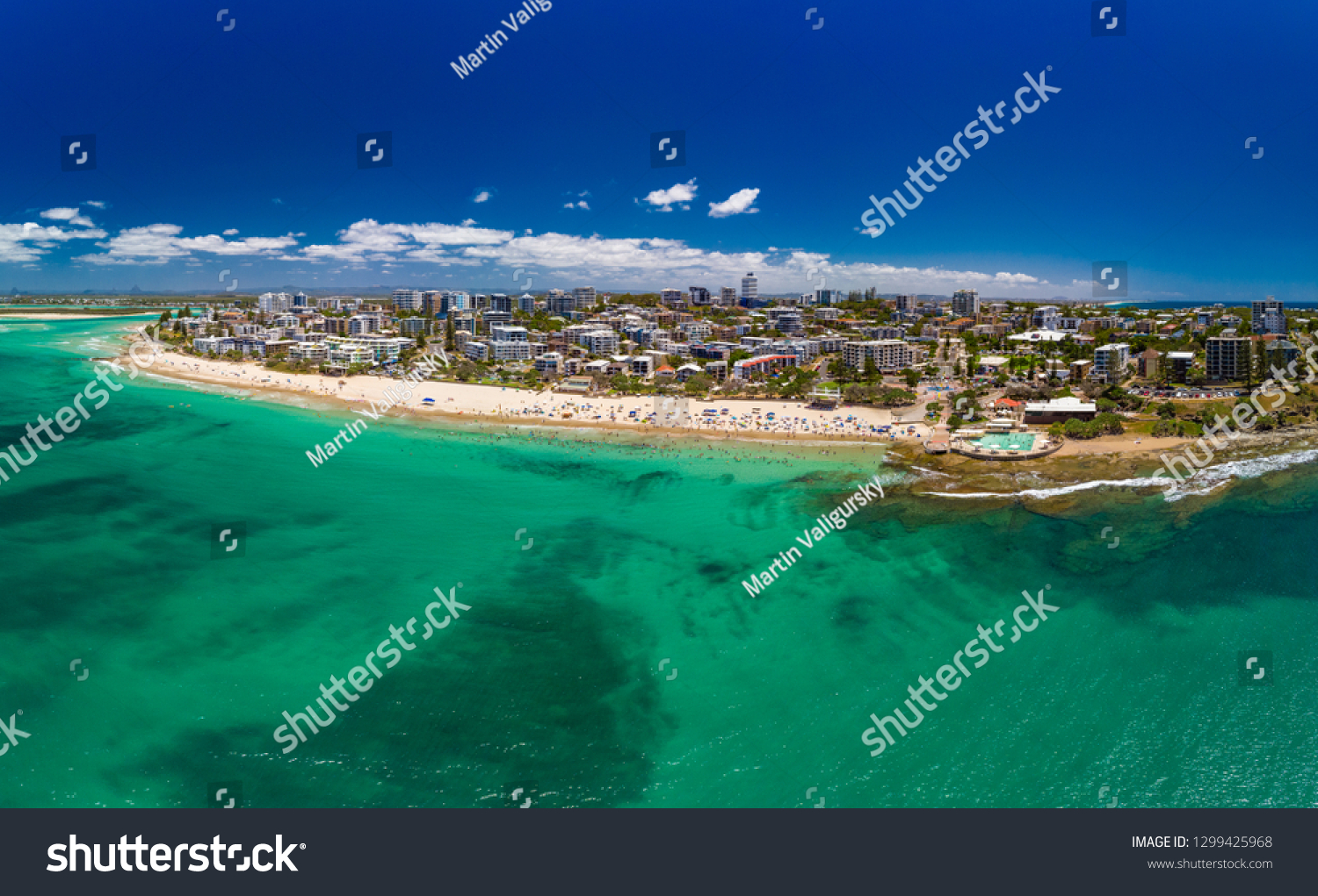 Aerial drone panoramic image of ocean waves on a busy Kings beach, Caloundra, Queensland, Australia #1299425968