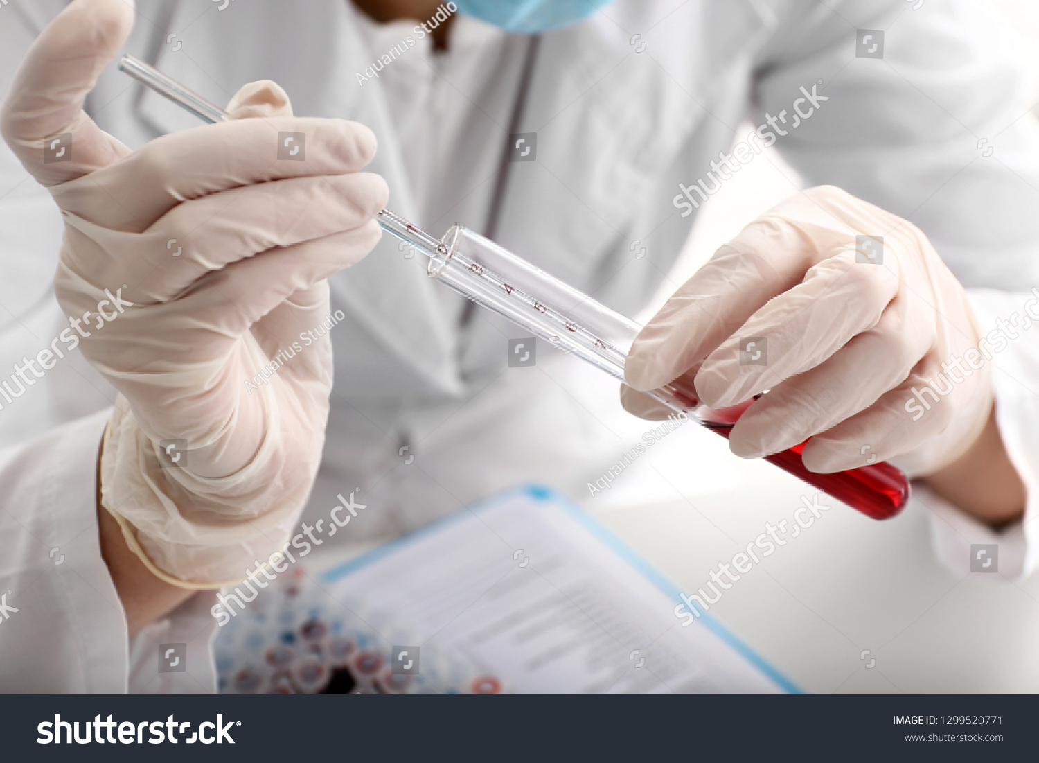 Woman working with blood sample in laboratory, closeup #1299520771