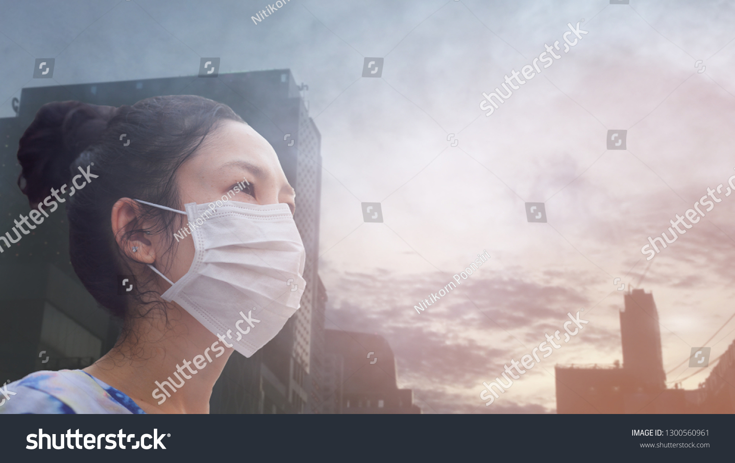women wearing facial hygienic mask for Safety outdoor. People in masks because of fine dust in thailand. Problems found in major cities around the world. air pollution,Environmental awareness concept #1300560961