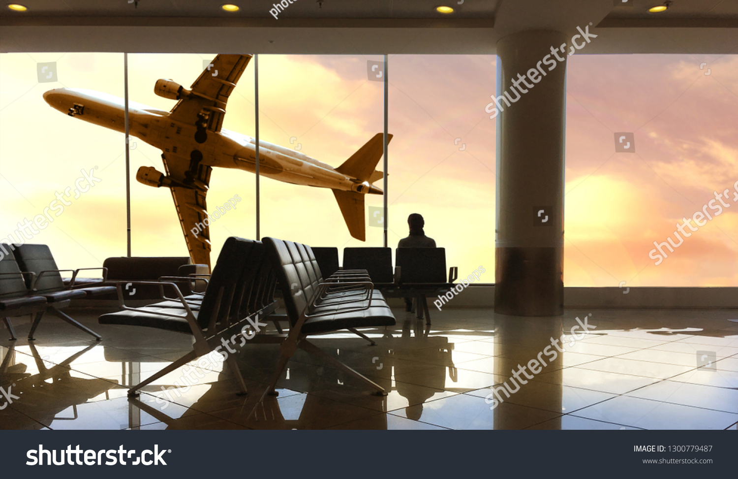 a Traveler waiting for flight at the airport #1300779487