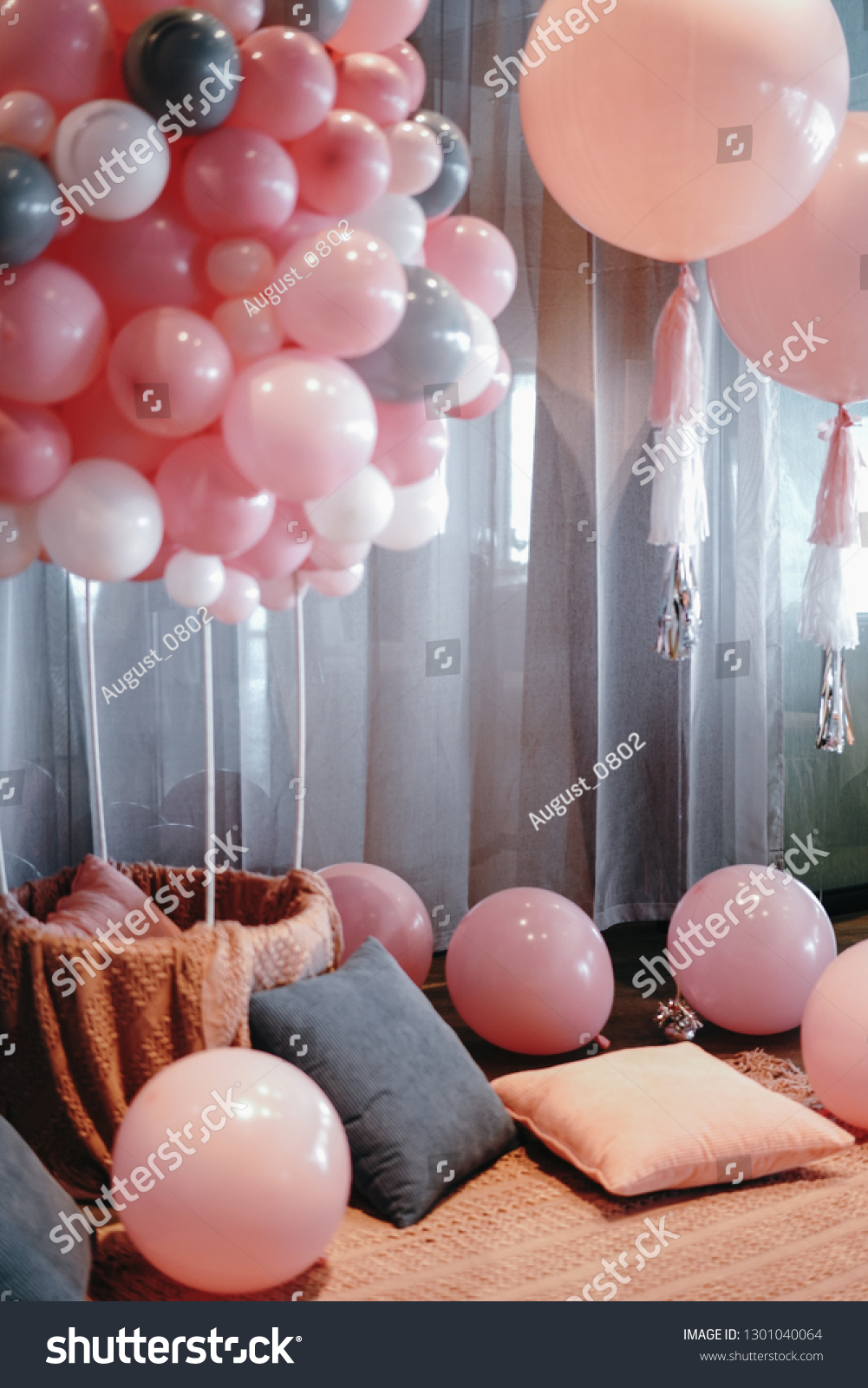 Many pink balloons and cushions with window screening in the lobby. #1301040064