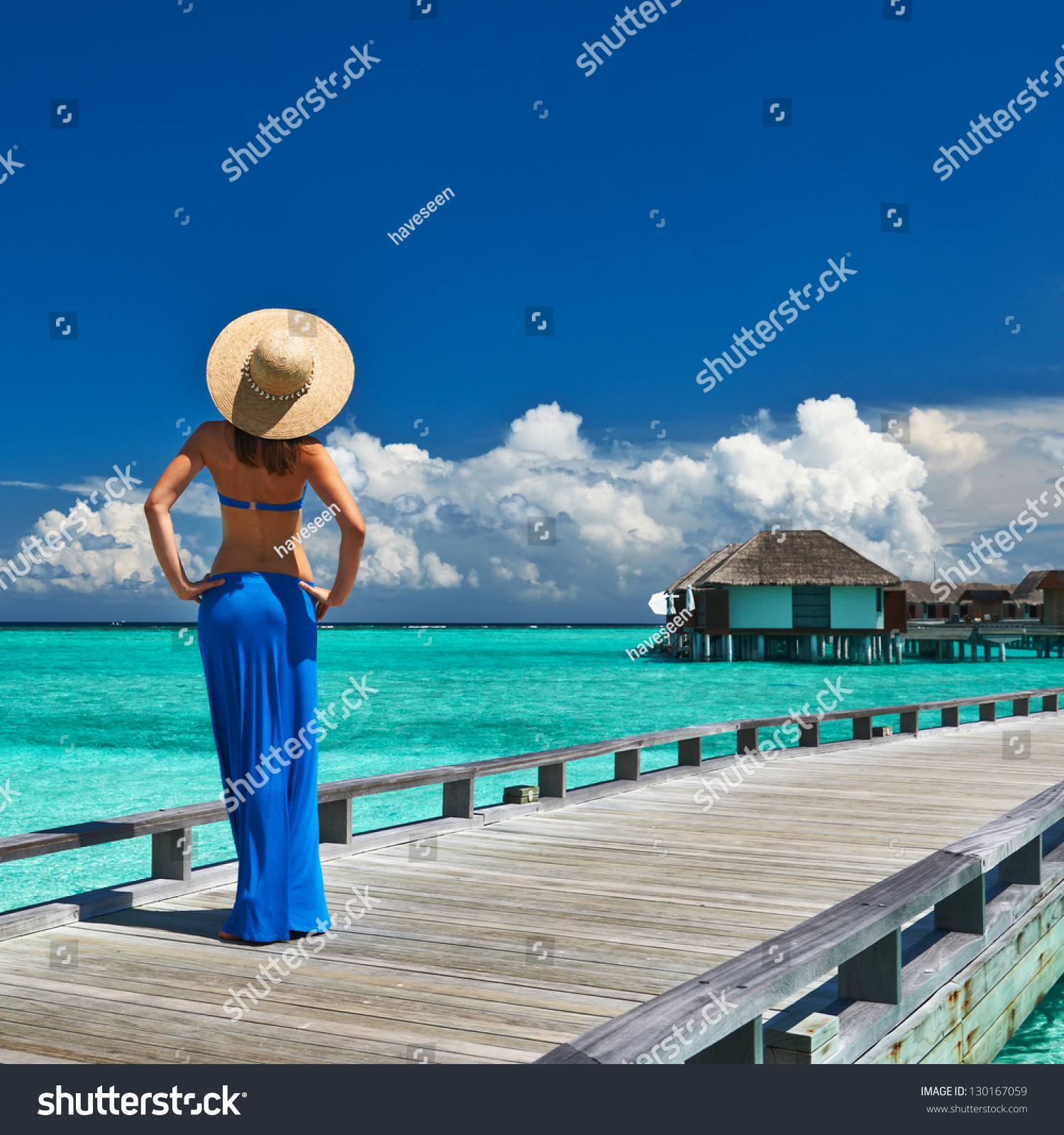Woman on a tropical beach jetty at Maldives #130167059