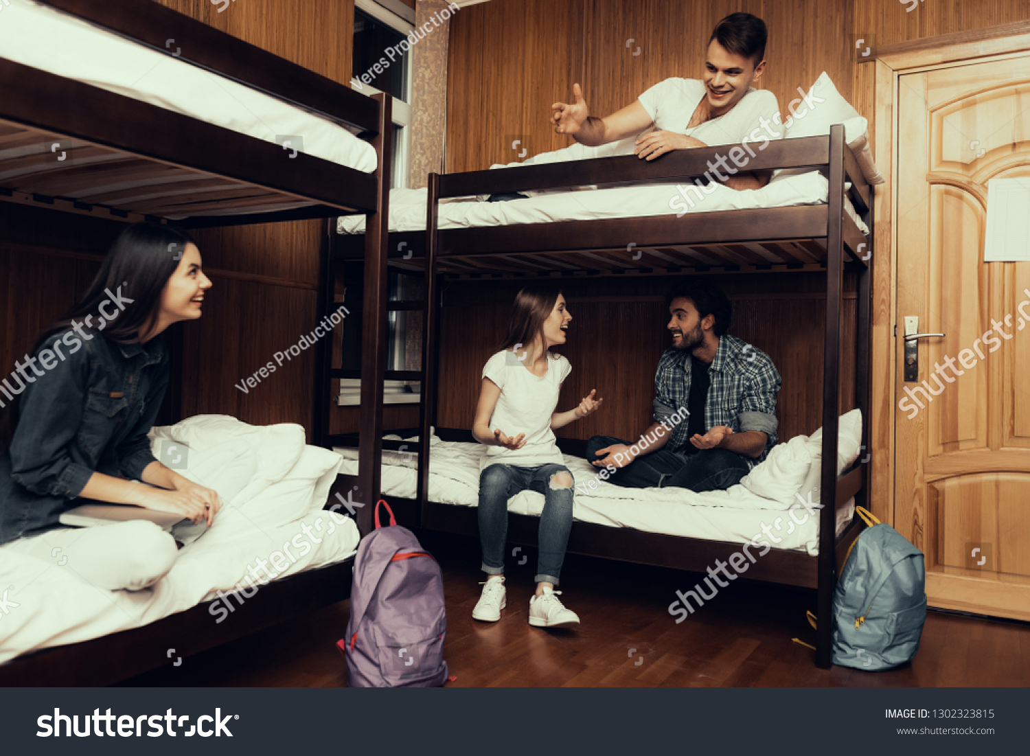 Hostel for Young People. Best Friends Traveling. Small Room in Hostel. spend time Together. bunk beds in room. Friends Sleeping. overnight in Hostel. got up first. sitting with boys. communicate #1302323815