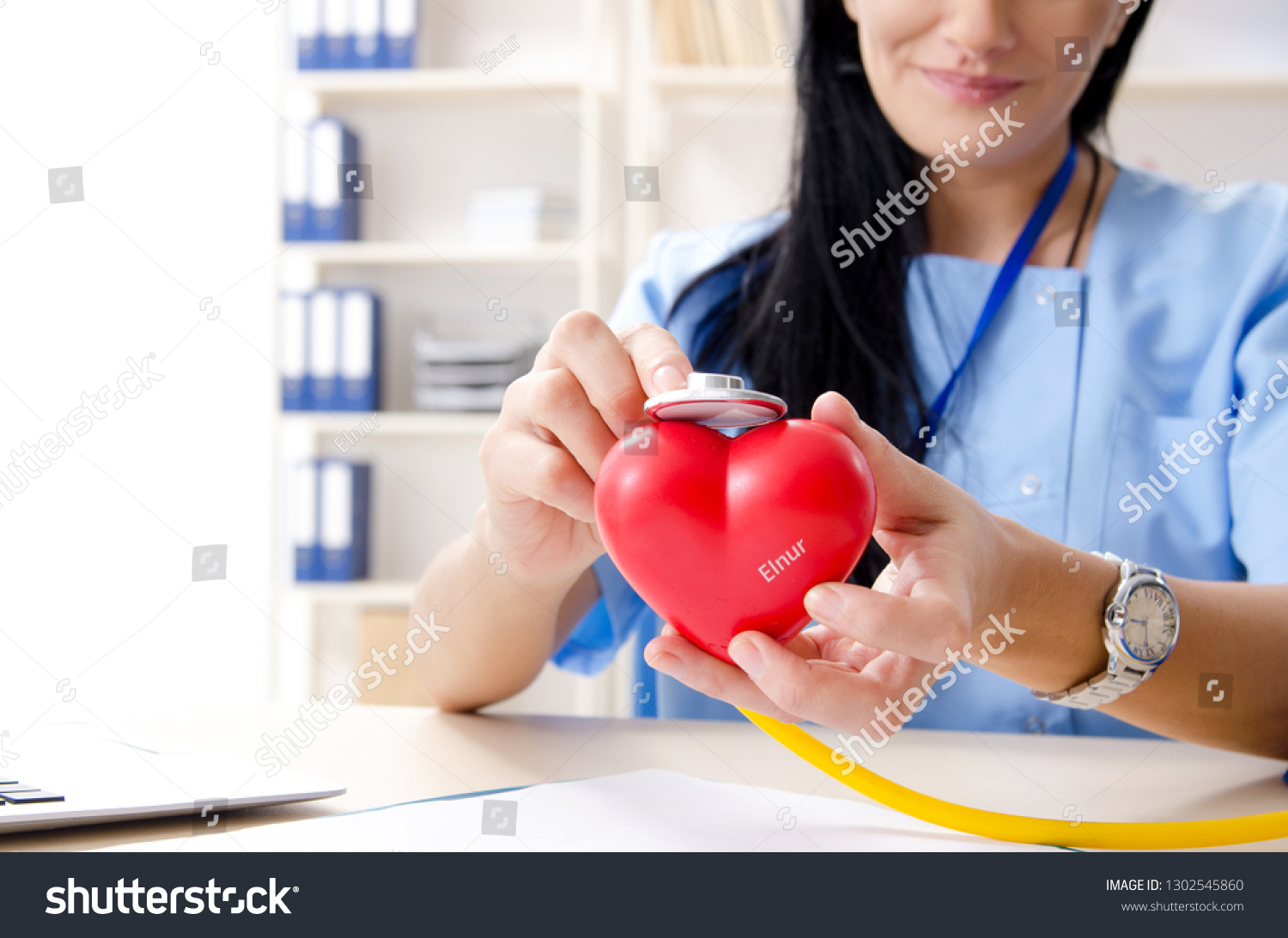 Female doctor cardiologist working in the clinic #1302545860