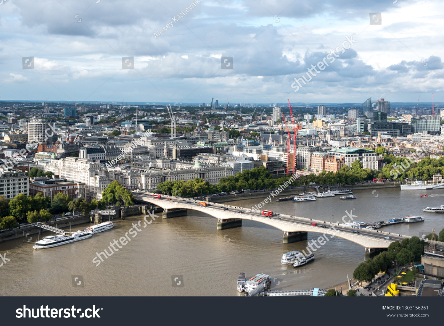 Thames river and city buildings in London in cloudly day, United Kingdom #1303156261